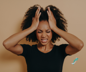 Young lady holding her head in anguish